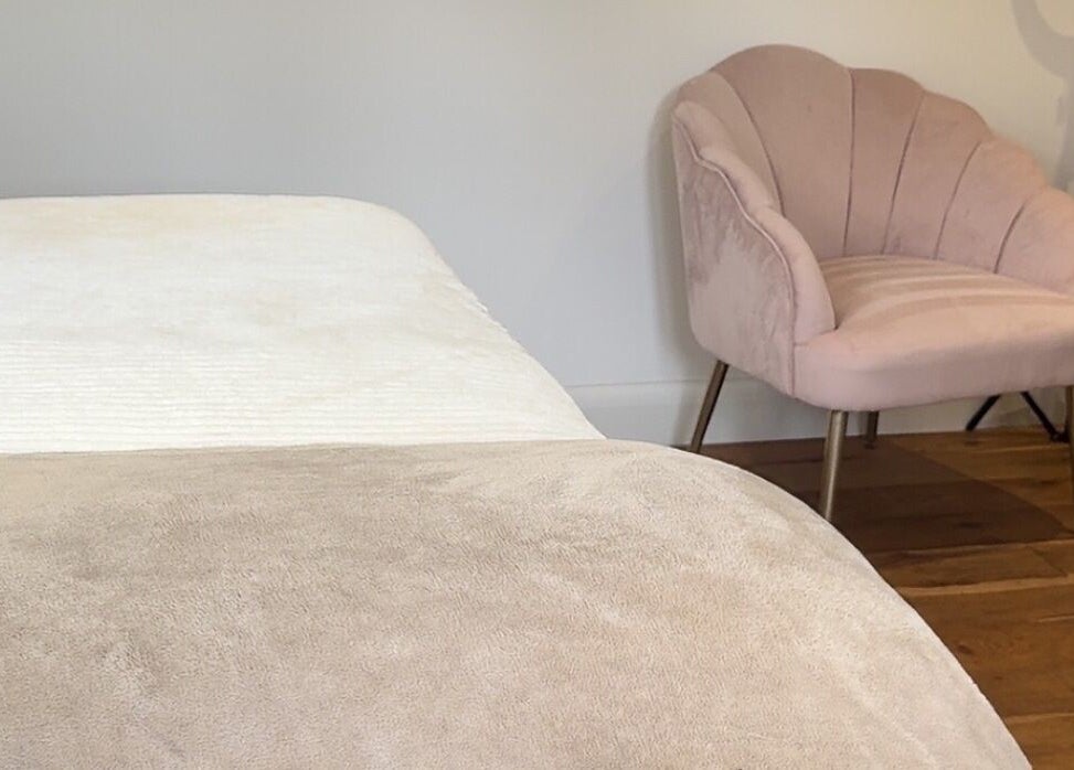 Comfortable treatment room at Arch & Lash Co., Guildford, England, GB, showcasing a cozy pink chair.