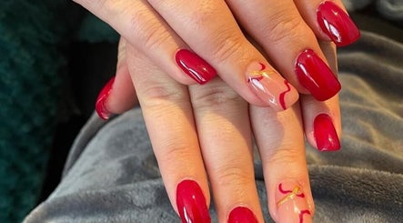 Chic red manicured nails at Carol nail bar, Sandton, Gauteng, ZA, showcasing artistic flair.