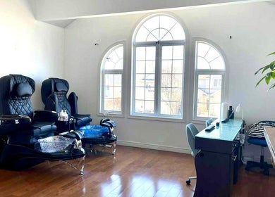 Relaxing pedicure chairs at Jenny Khmer Nails & Spa, London, Ontario, CA, under natural light from arched windows.
