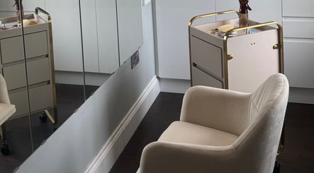 Stylish salon interior at The Tape Studio, Huddersfield, England, GB with a plush chair and sleek mirrors.