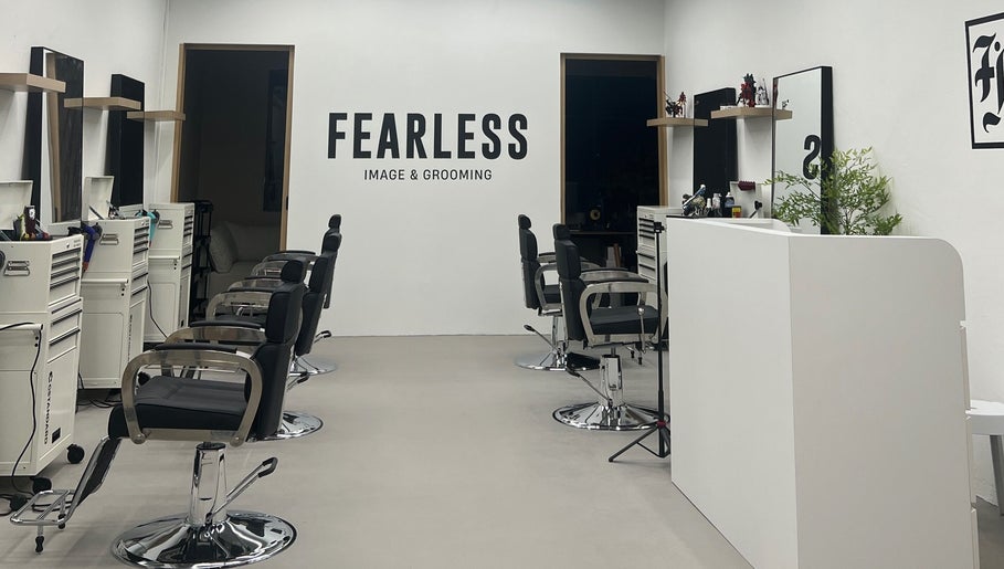 Interior of Fearless Image & Grooming salon in Singapore, SG showcasing modern styling chairs and minimal decor.