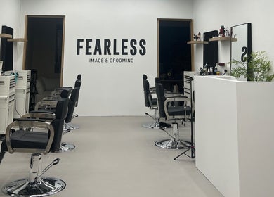 Interior of Fearless Image & Grooming salon in Singapore, SG showcasing modern styling chairs and minimal decor.