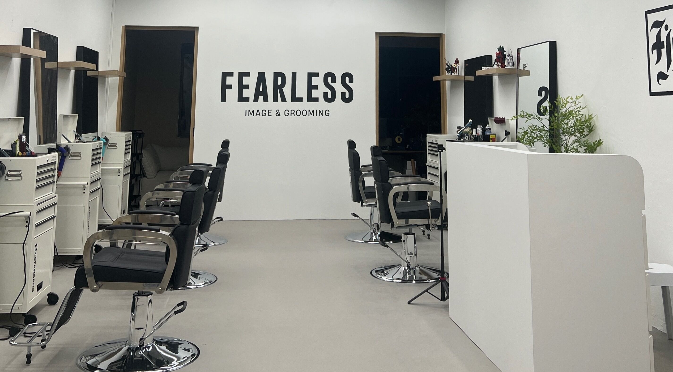 Interior of Fearless Image & Grooming salon in Singapore, SG showcasing modern styling chairs and minimal decor.