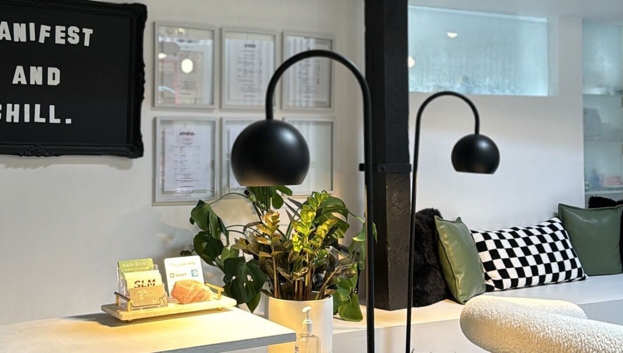 Inviting lounge at Diveyen Lash, Ottawa, CA with modern decor and lush plants.