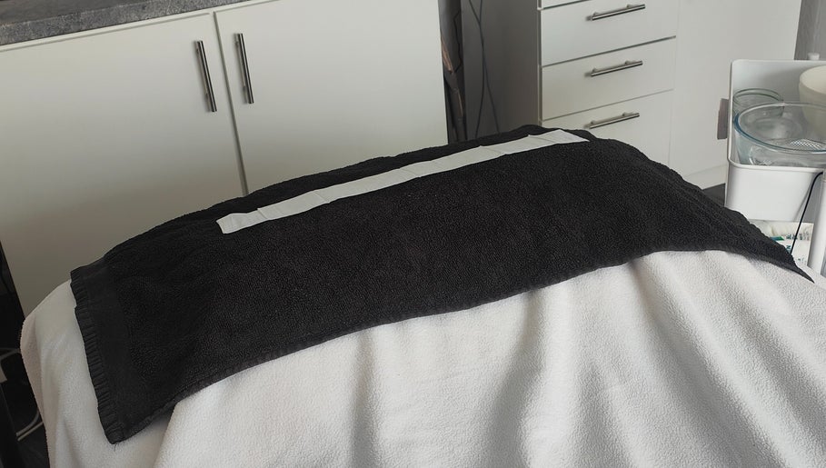 Spa treatment bed at Radiant Reflection, Coventry, England, GB with cozy black towel.