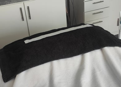 Spa treatment bed at Radiant Reflection, Coventry, England, GB with cozy black towel.