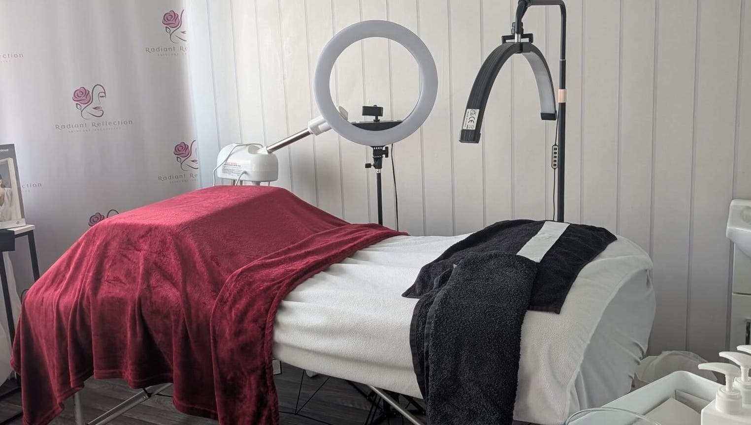 Elegant treatment room at Radiant Reflection, Coventry, England, GB showcasing plush linens and equipment.