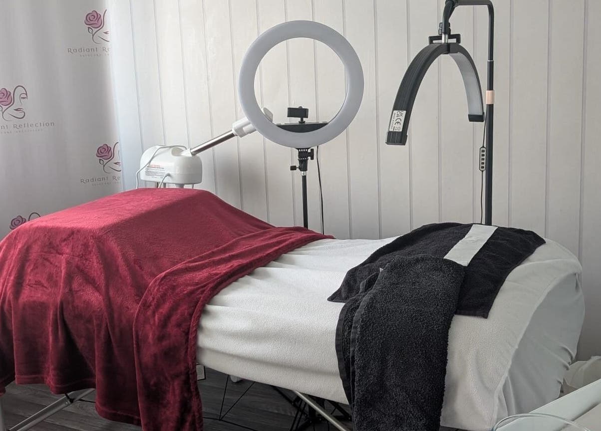Elegant treatment room at Radiant Reflection, Coventry, England, GB showcasing plush linens and equipment.