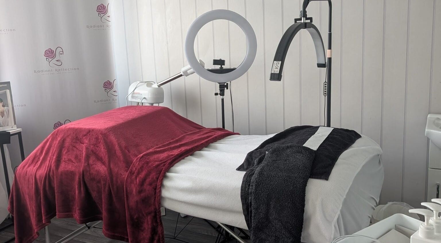 Elegant treatment room at Radiant Reflection, Coventry, England, GB showcasing plush linens and equipment.
