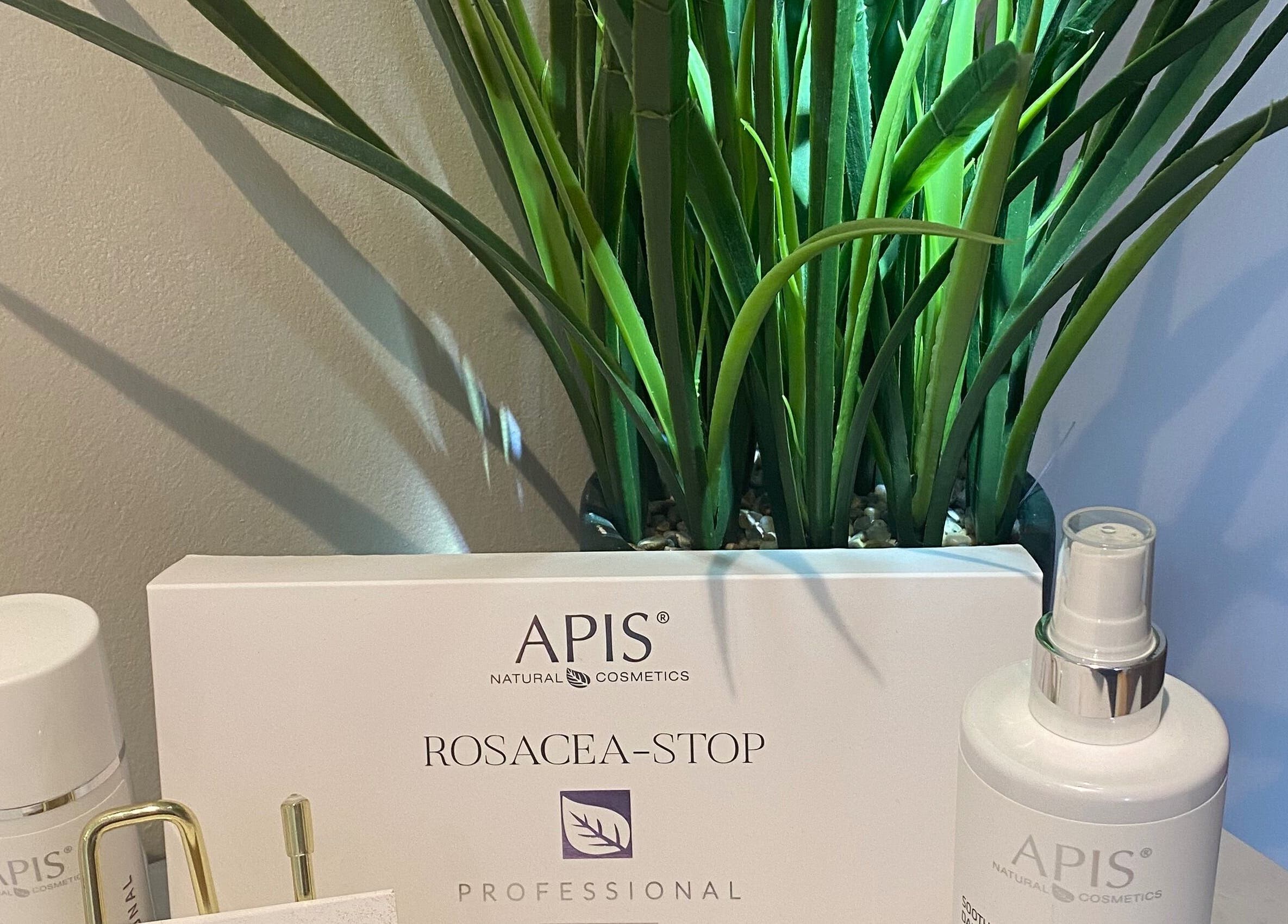 Beauty products at Facial Aesthetics Clinic East Scotland in Dunbar, Scotland, GB with lush green plant.