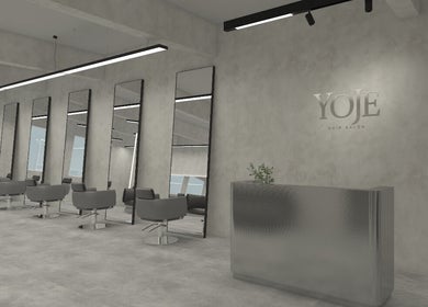 Modern interior of Yoje Salon in Kuala Lumpur, featuring sleek styling chairs and mirrors.