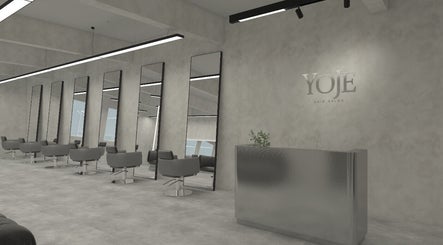 Modern interior of Yoje Salon in Kuala Lumpur, featuring sleek styling chairs and mirrors.