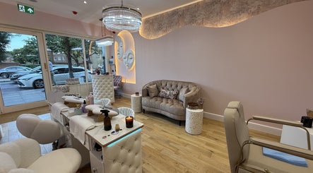 Chic interior of The Cream of Beauty salon, London, England, GB featuring plush seating and modern decor.