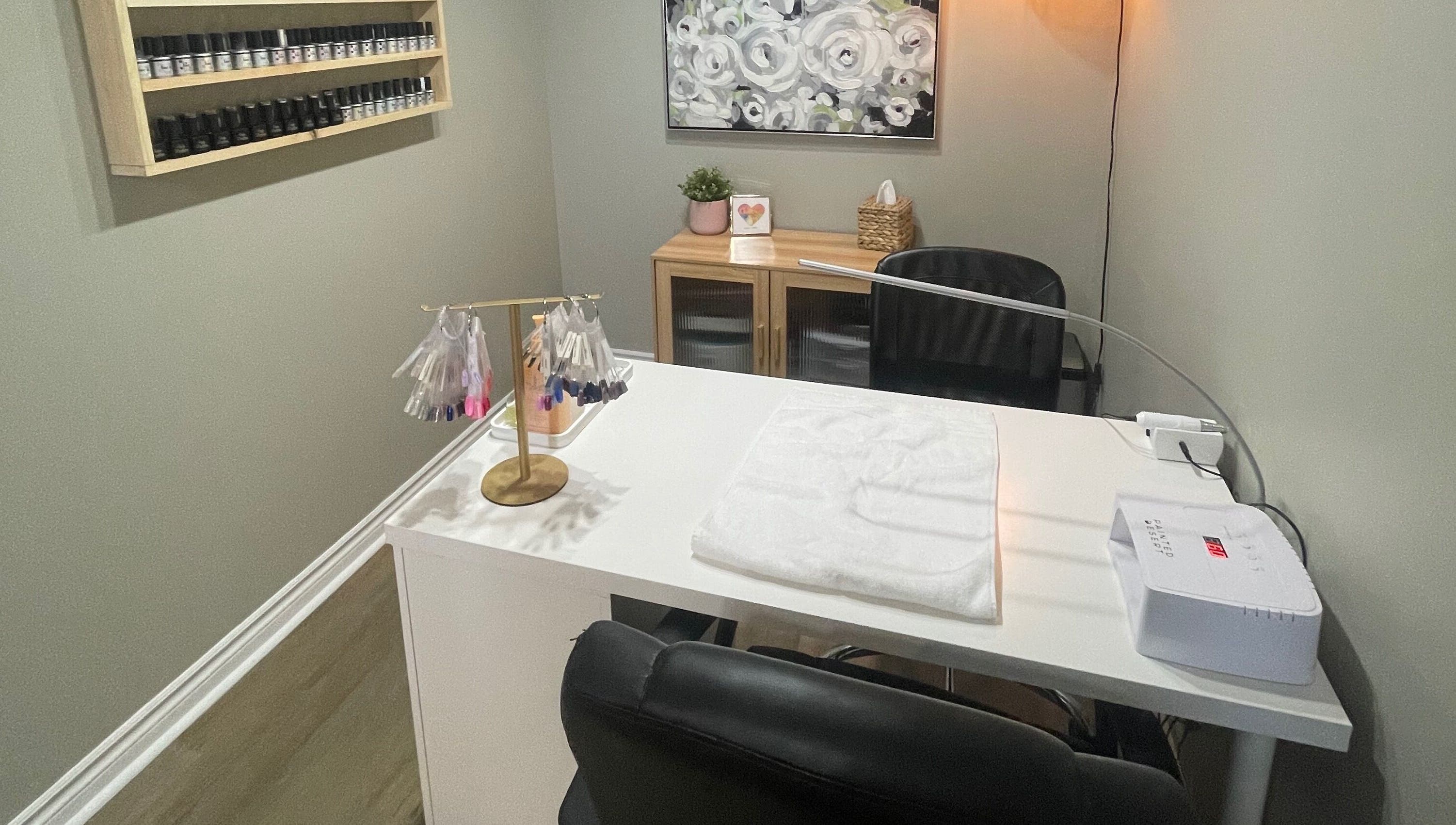 Modern nail salon workspace at Chelseas Esthetics, Sydney Mines, Nova Scotia, CA, featuring polish display.