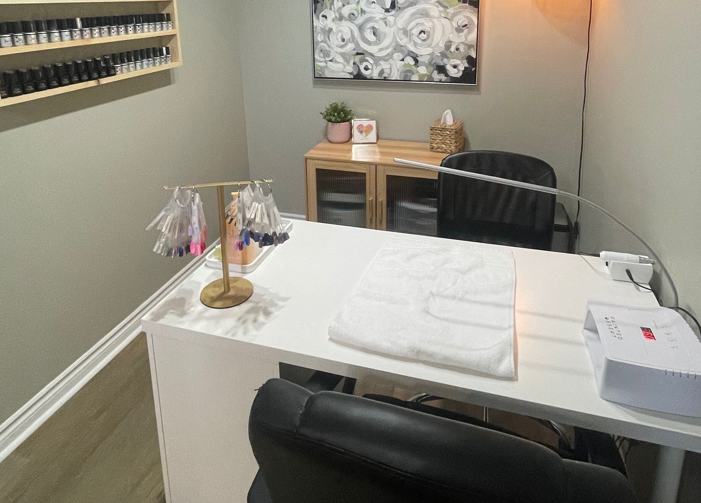 Modern nail salon workspace at Chelseas Esthetics, Sydney Mines, Nova Scotia, CA, featuring polish display.