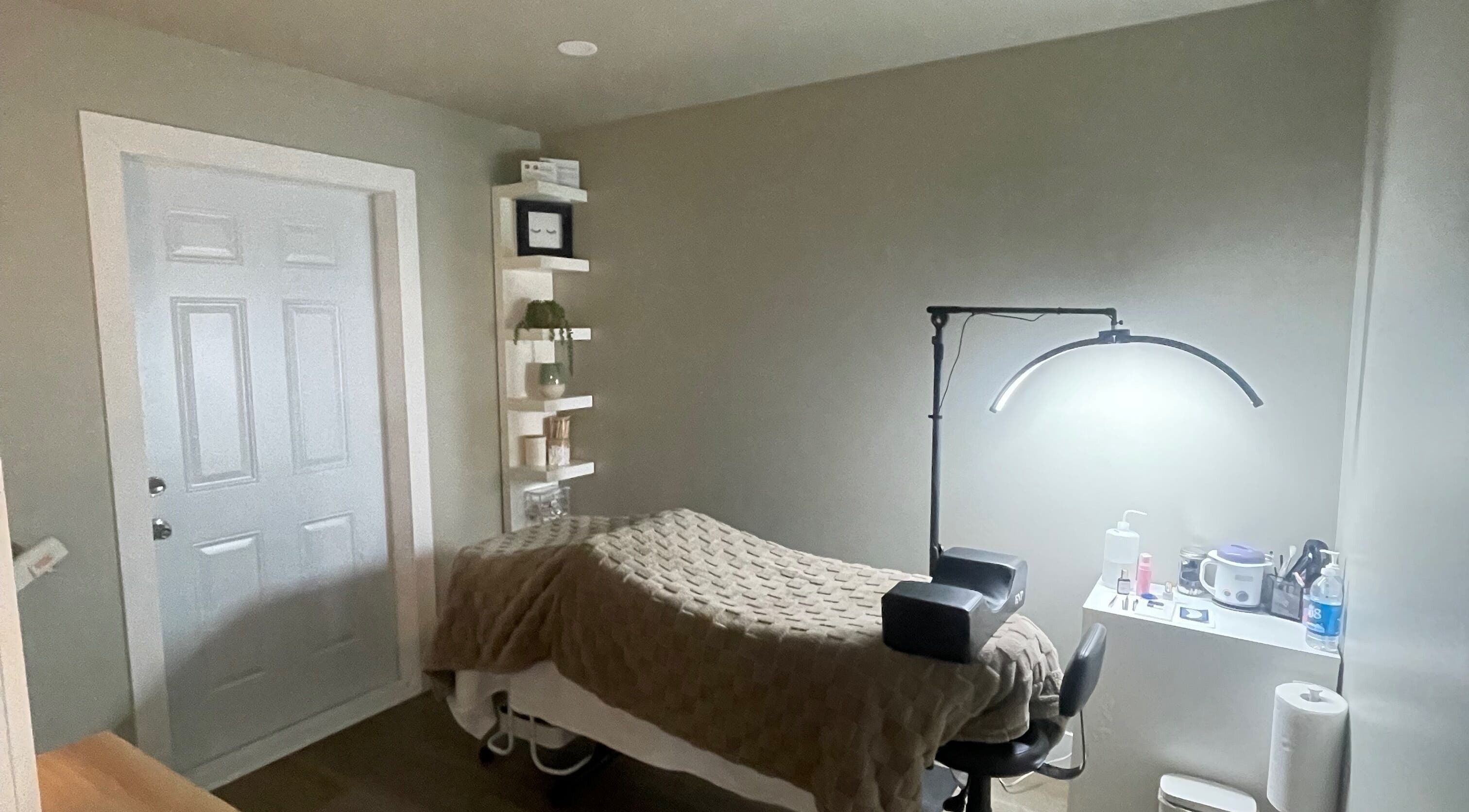 Cozy treatment room at Chelseas Esthetics in Sydney Mines, Nova Scotia, CA, featuring a massage bed and soft lighting.