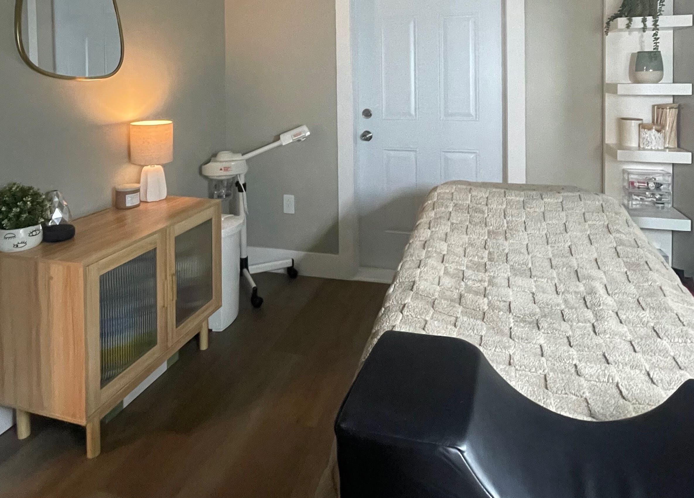 Inviting treatment room at Chelseas Esthetics, Sydney Mines, Nova Scotia, CA with comfortable bed and decor.