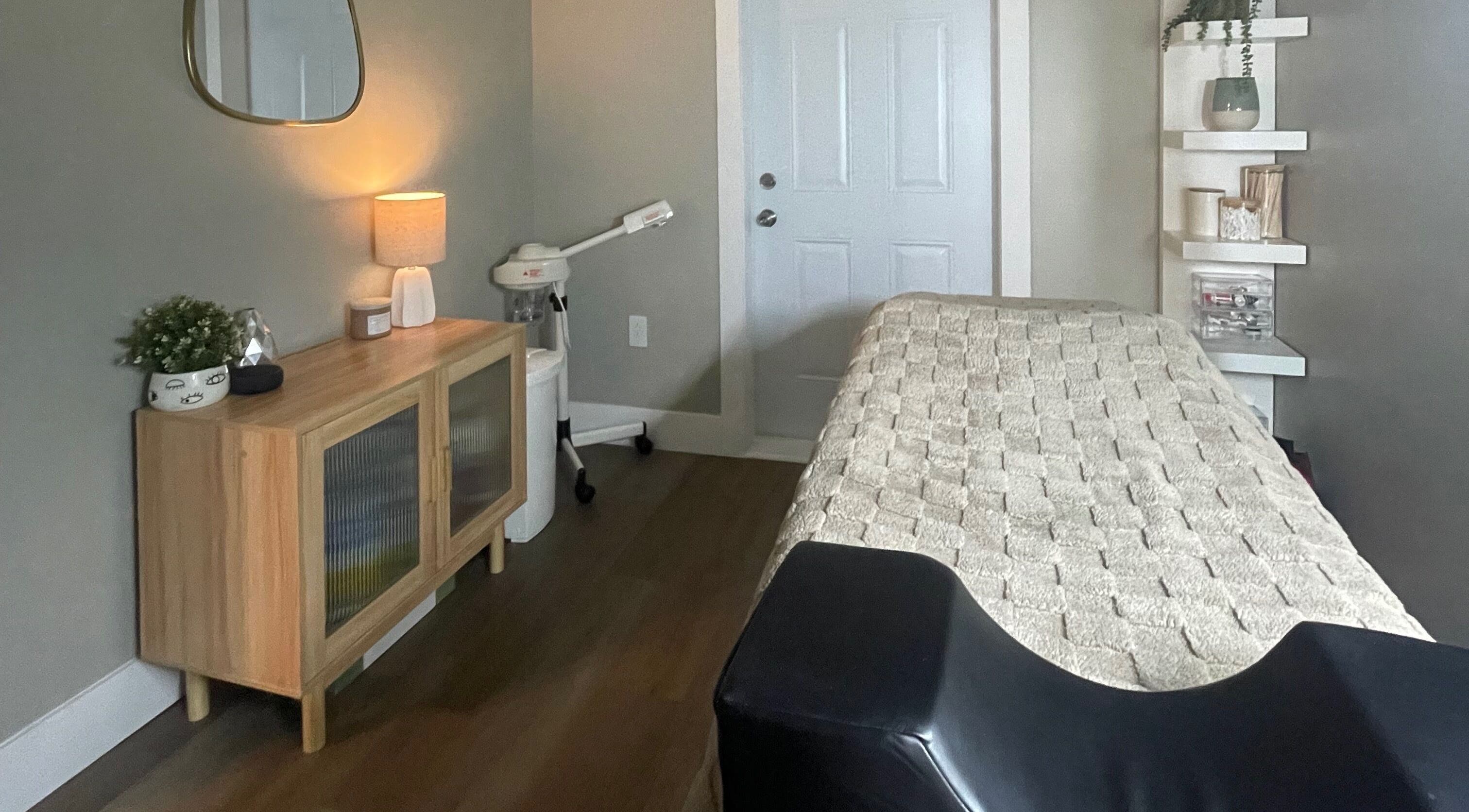 Inviting treatment room at Chelseas Esthetics, Sydney Mines, Nova Scotia, CA with comfortable bed and decor.