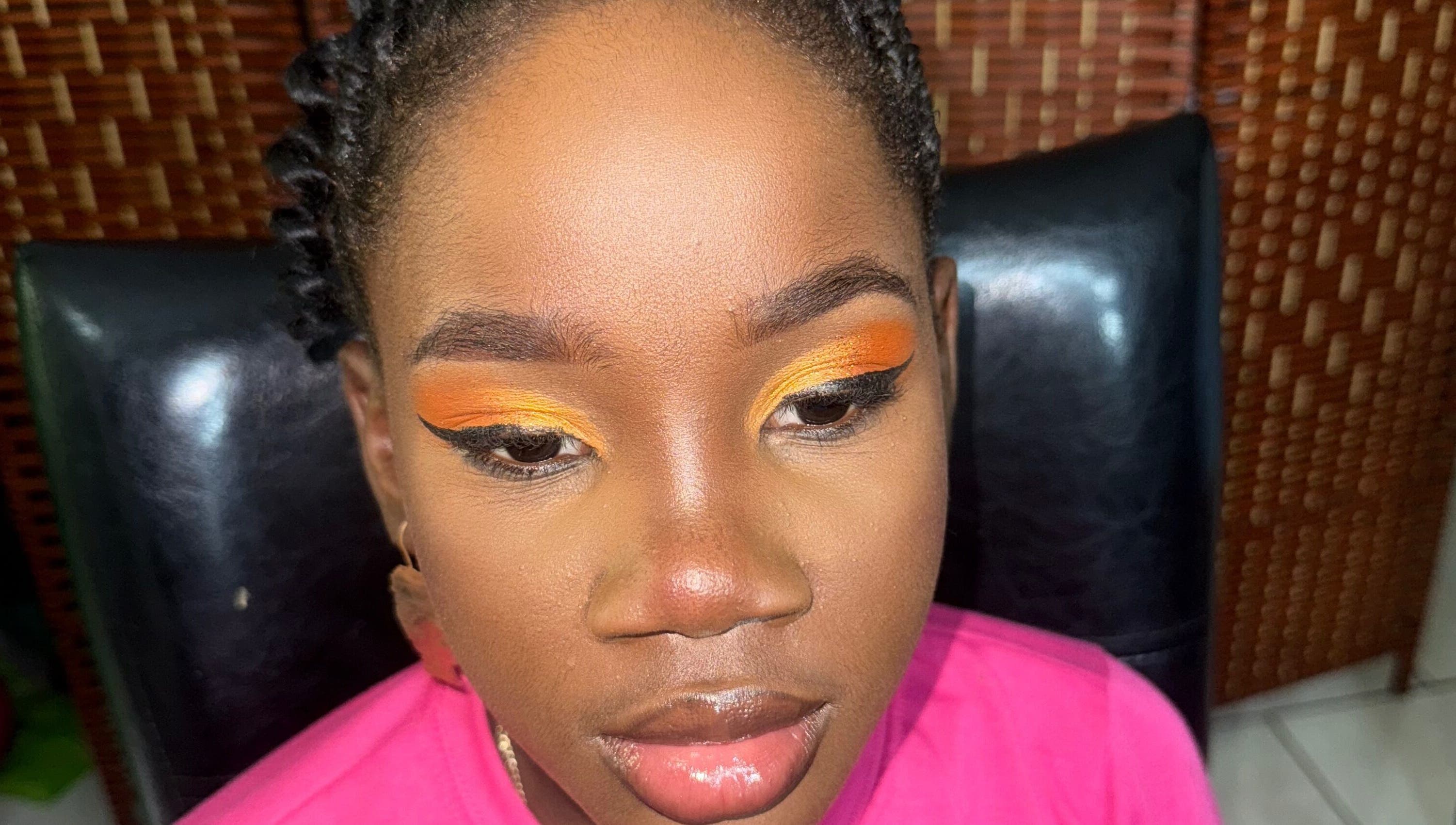 Close-up of vibrant eye makeup featuring orange hues at GLOWED BY TAMMY, Roseau, Saint George Parish, DM.