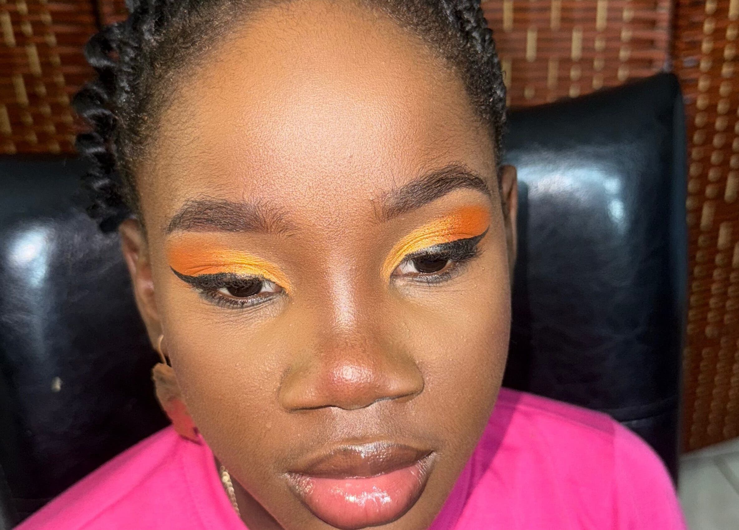 Close-up of vibrant eye makeup featuring orange hues at GLOWED BY TAMMY, Roseau, Saint George Parish, DM.