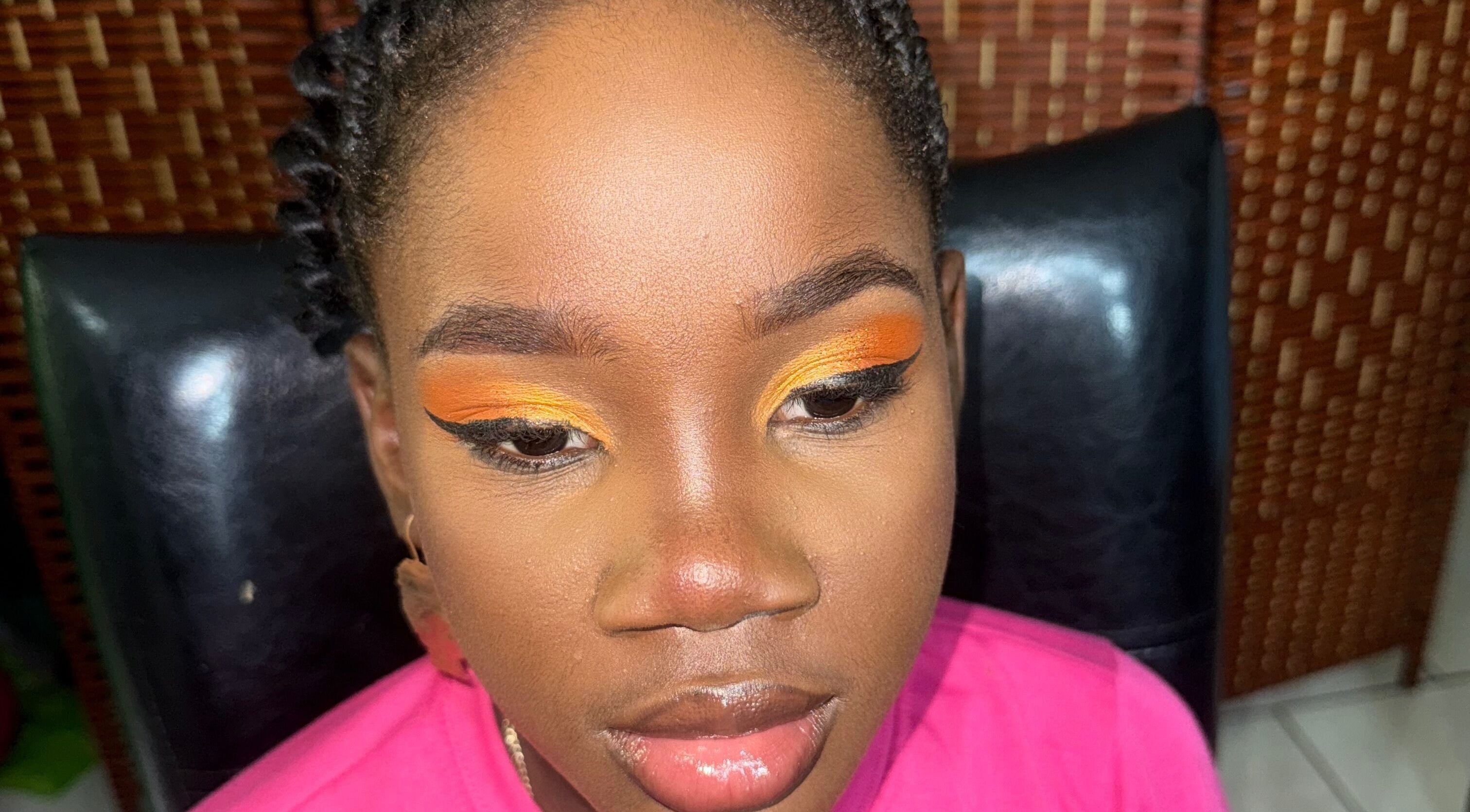 Close-up of vibrant eye makeup featuring orange hues at GLOWED BY TAMMY, Roseau, Saint George Parish, DM.