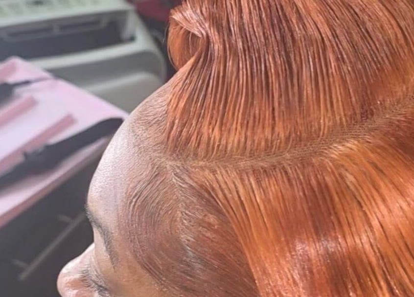 A sleek copper hairstyle at GLOWED BY TAMMY in Roseau, Saint George Parish, DM, showcasing expert styling.