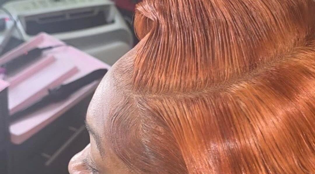 A sleek copper hairstyle at GLOWED BY TAMMY in Roseau, Saint George Parish, DM, showcasing expert styling.