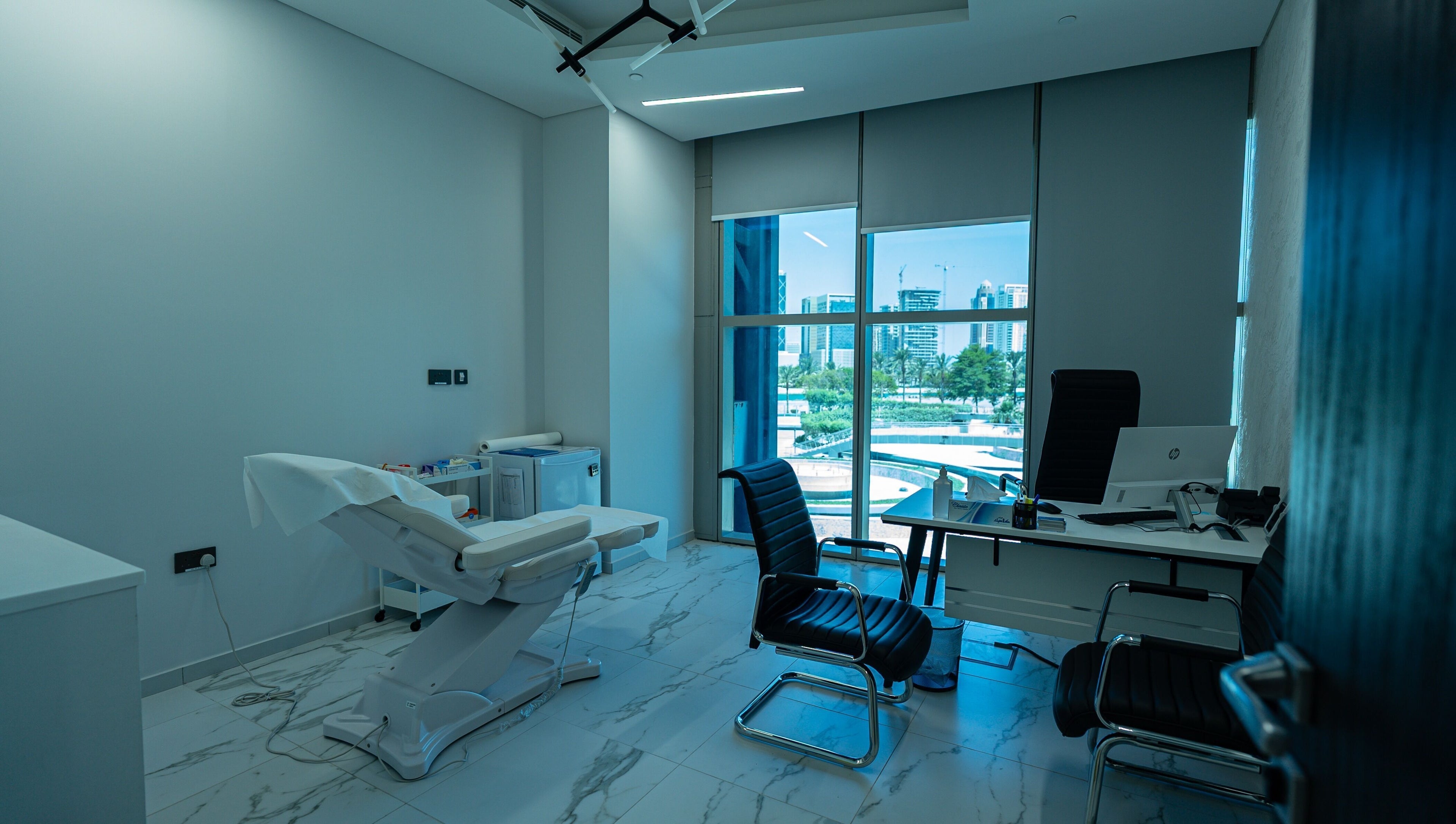 Modern treatment room at Boulevard Clinic in Doha, Doha Municipality, QA with cityscape view.