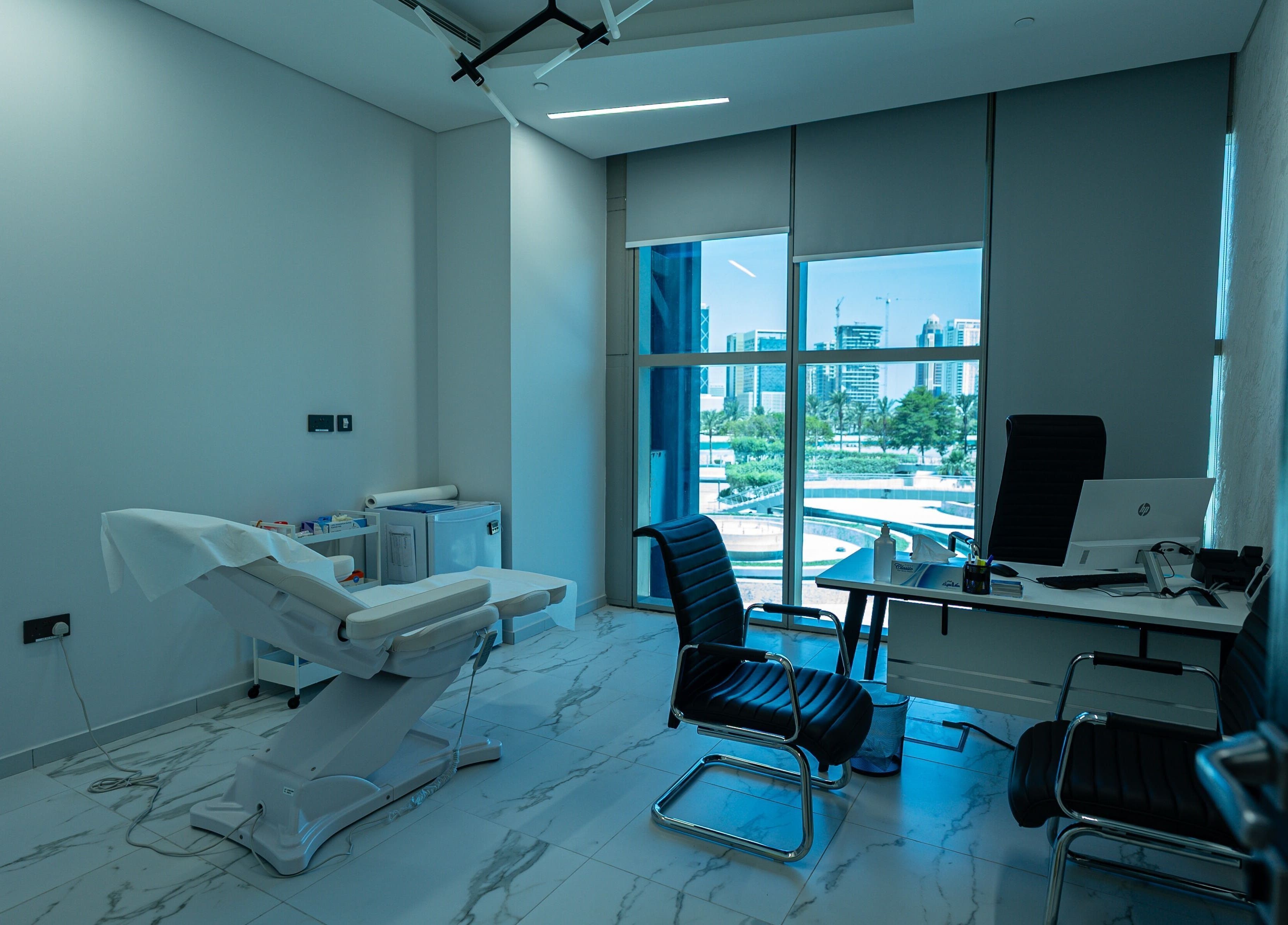 Modern treatment room at Boulevard Clinic in Doha, Doha Municipality, QA with cityscape view.