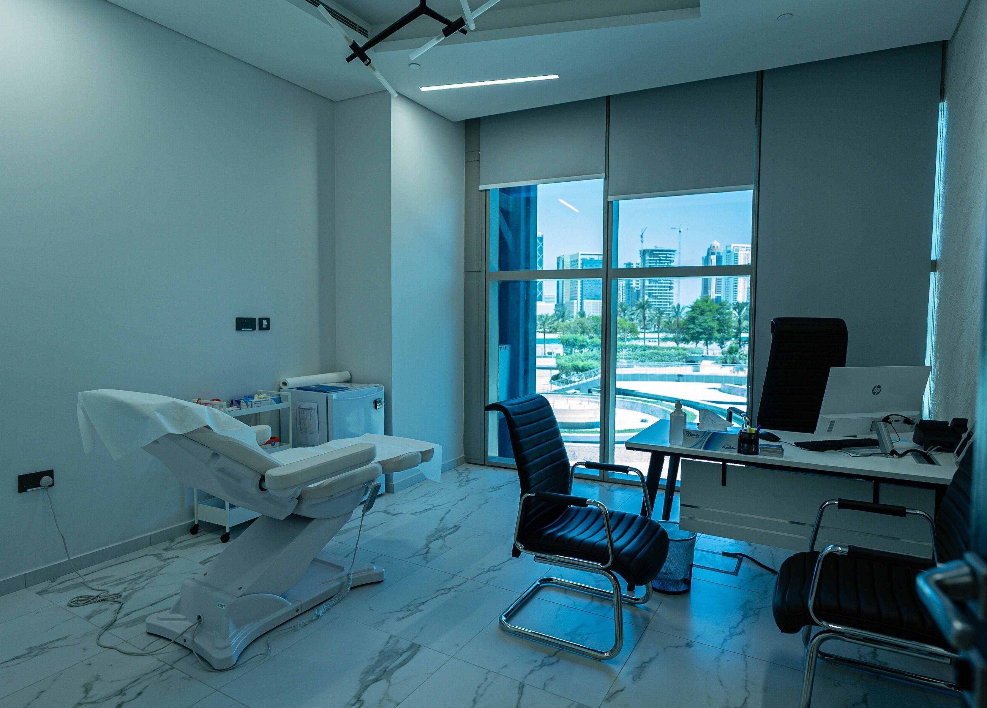 Modern treatment room at Boulevard Clinic in Doha, Doha Municipality, QA with cityscape view.