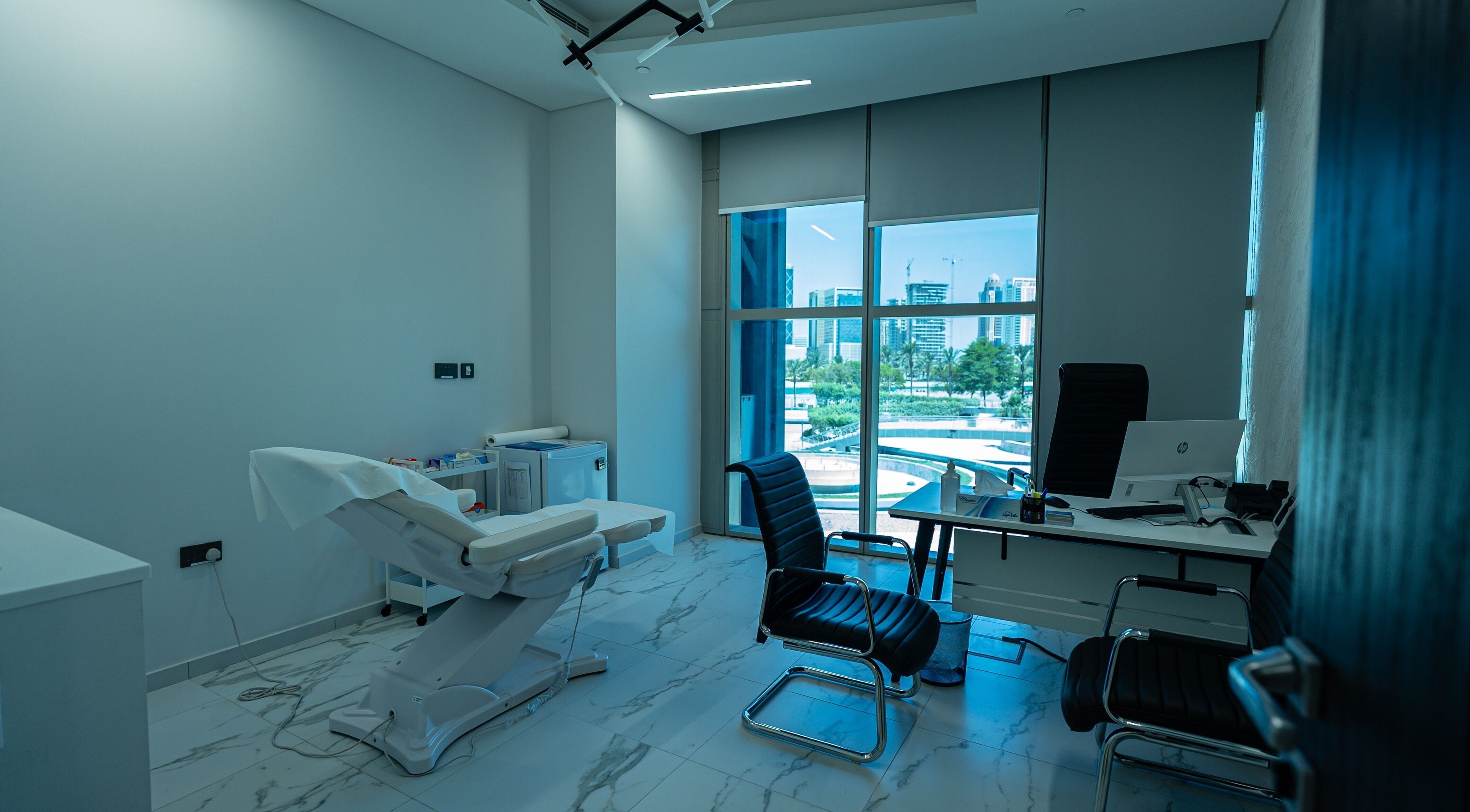 Modern treatment room at Boulevard Clinic in Doha, Doha Municipality, QA with cityscape view.