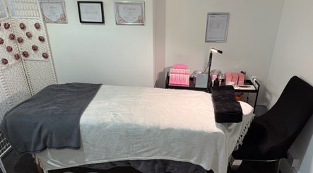 Relaxing treatment room at Lala’s Luxe Beauty in Maidstone, England, GB with cozy spa bed and decor.