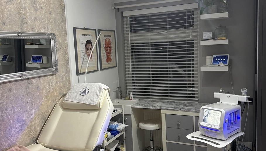 Modern beauty treatment room at KatK Beauty, Harlow, England, GB, featuring comfy seating and high-tech equipment.