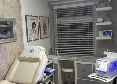Modern beauty treatment room at KatK Beauty, Harlow, England, GB, featuring comfy seating and high-tech equipment.