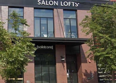 Exterior of Glow With Lindsay's wellness center in Chicago, Illinois, US, featuring sleek architecture and lush greenery.