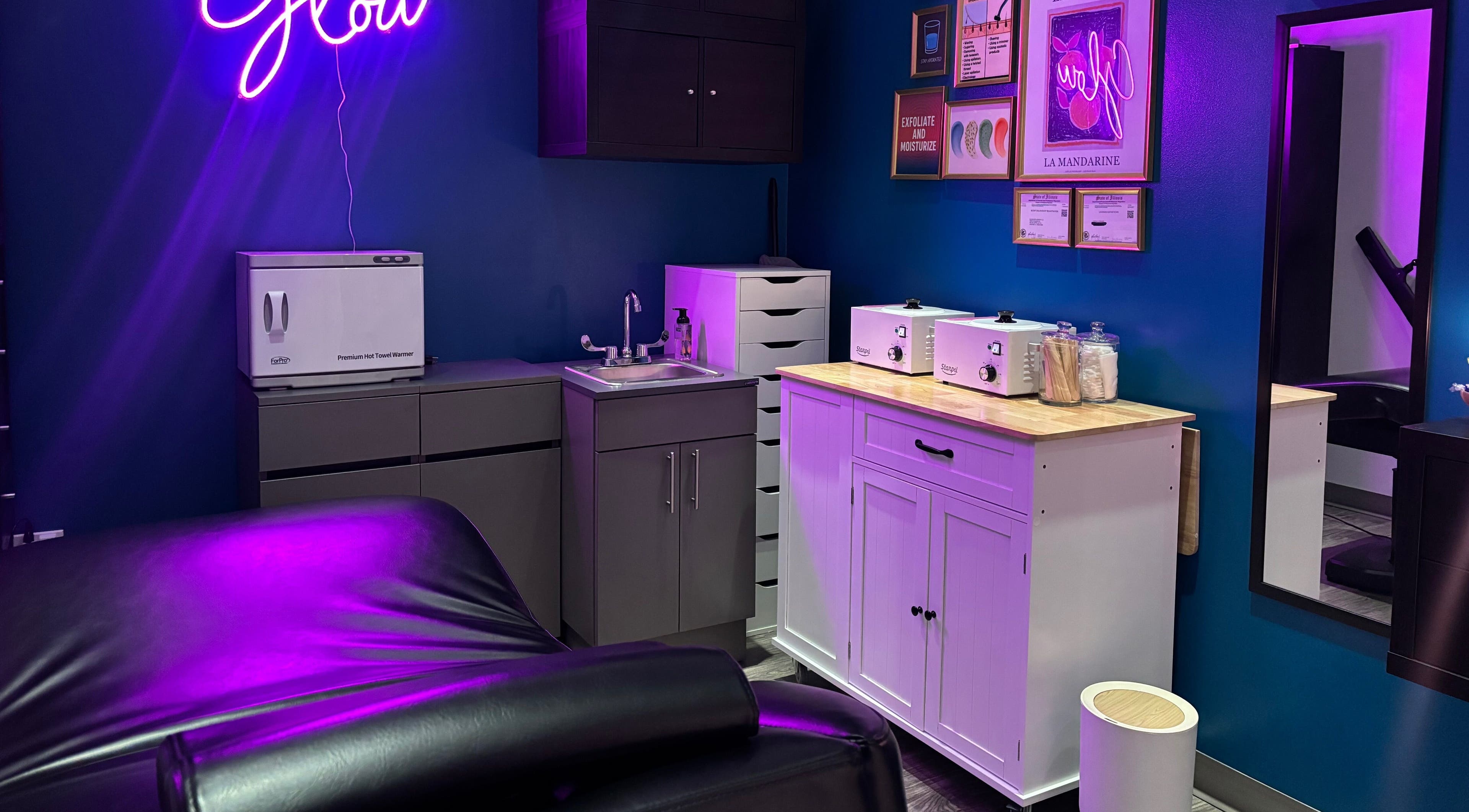 Relaxing treatment room at Glow With Lindsay, Chicago, Illinois, US, featuring modern decor and soothing lights.