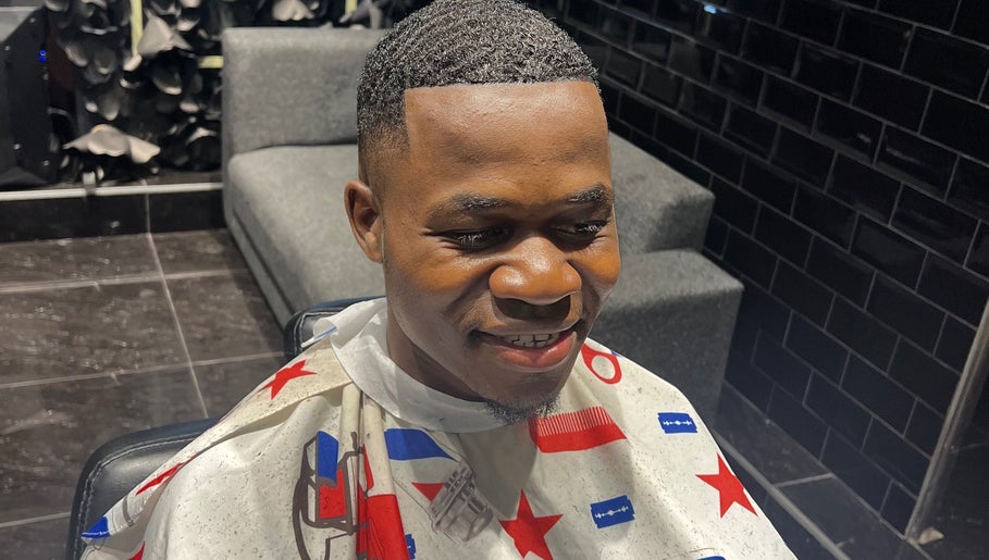 A fresh haircut at JOSHUA BARBER Cape Town, Western Cape, ZA shows expert styling in a sleek barbershop setting.