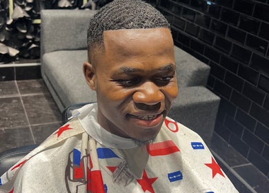 A fresh haircut at JOSHUA BARBER Cape Town, Western Cape, ZA shows expert styling in a sleek barbershop setting.