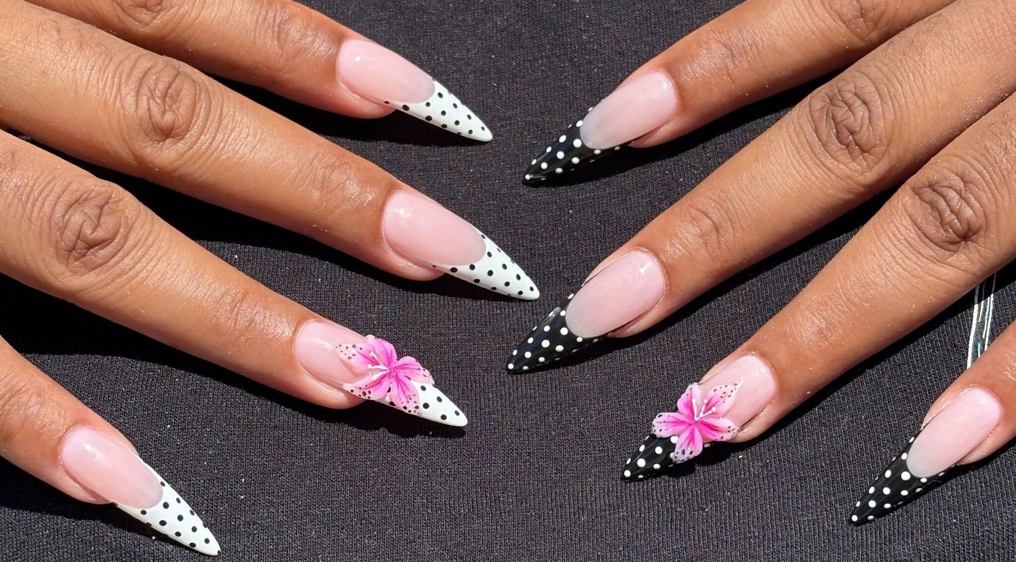 Stunning polka-dot nails with floral accents at Nail Haus, Toronto, Ontario, CA.