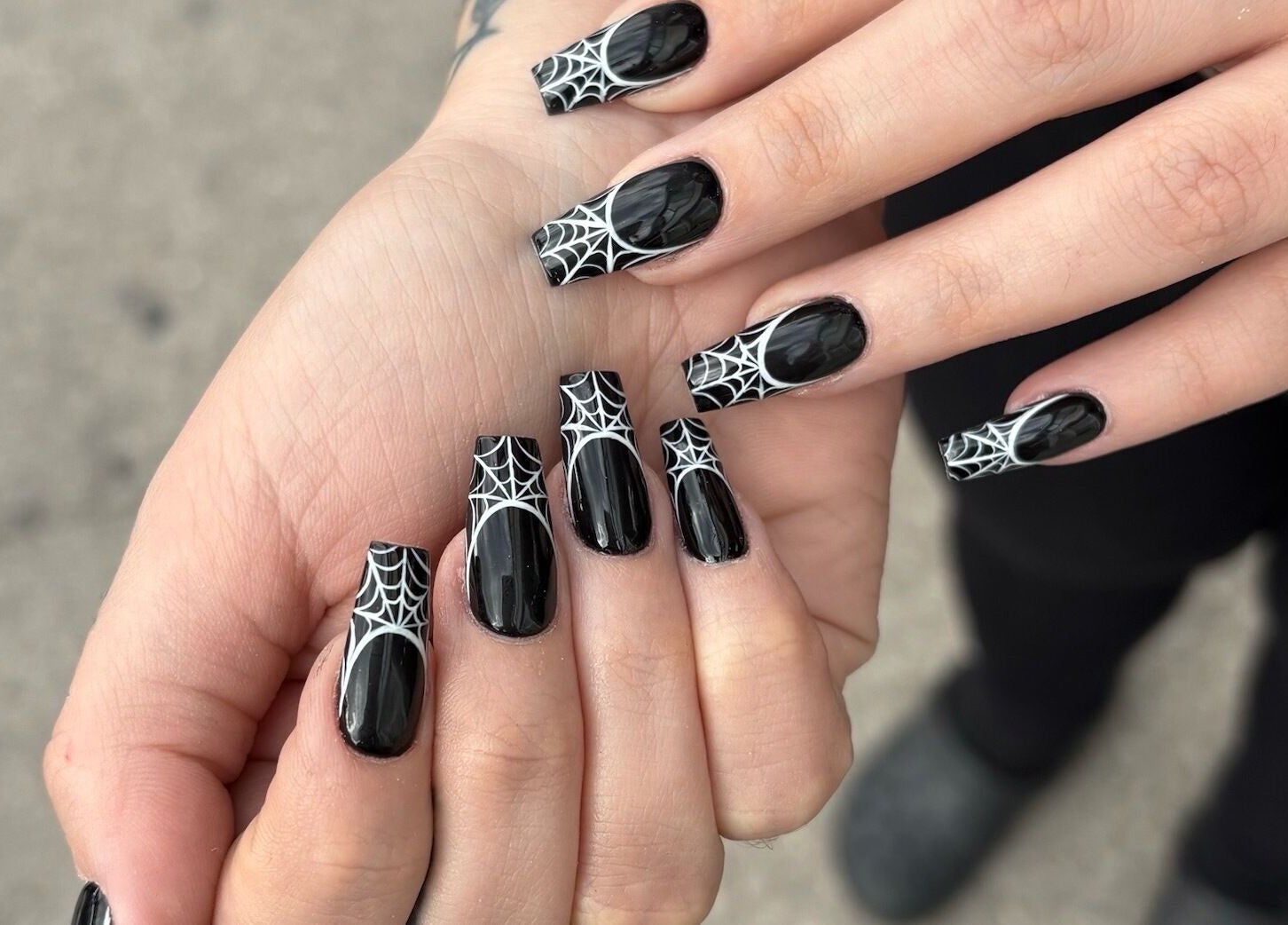 Spiderweb nail art at Nail Haus, Toronto, Ontario, CA, showcasing chic black and white design.