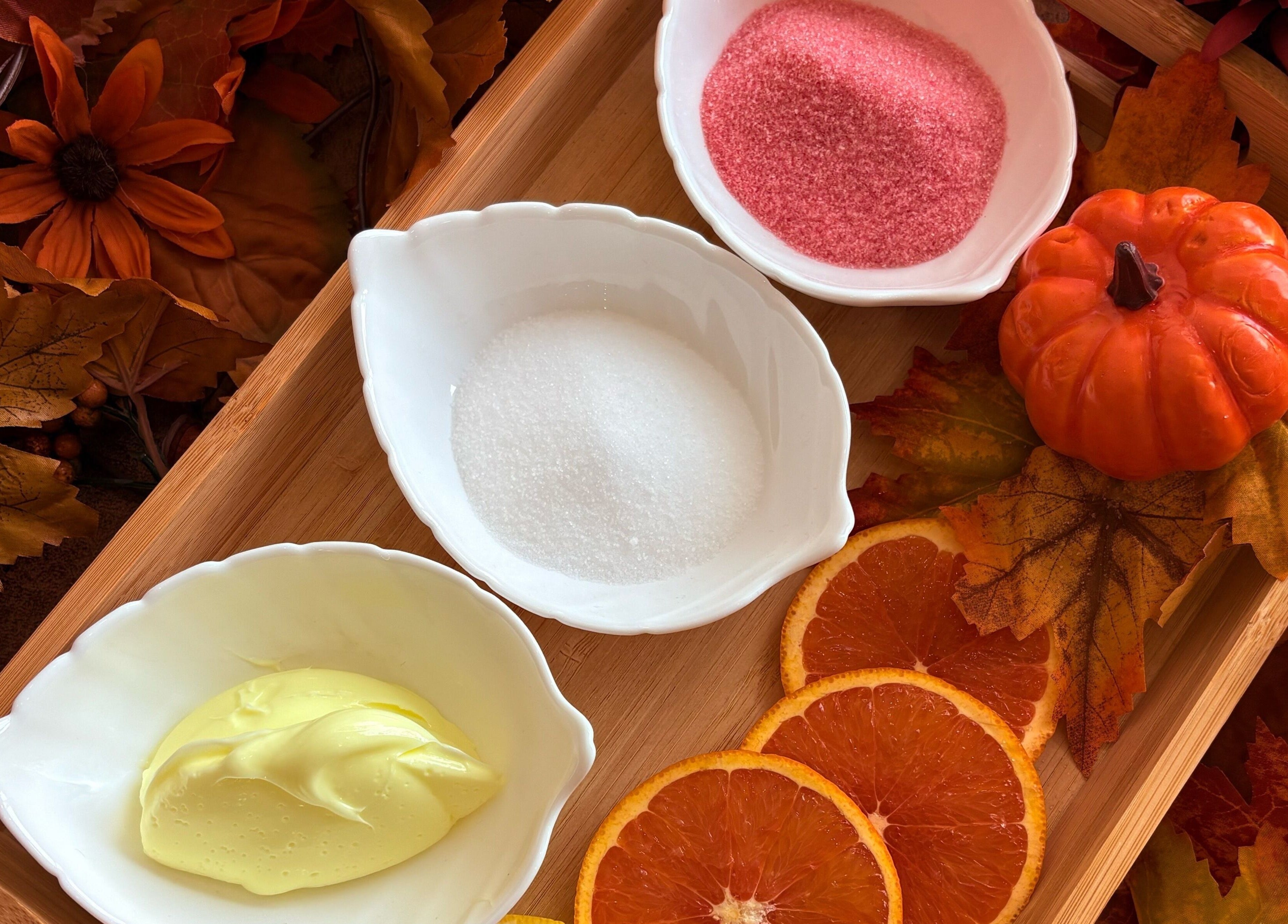 Autumn-themed spa ingredients at Nail Haus, Toronto, Ontario, CA, featuring vibrant oranges and flowers.