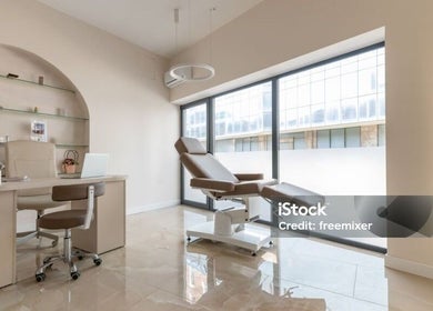 Modern treatment room at House of S, Langemark-poelkapelle, Vlaanderen, BE. Features plush chair and sleek desk.