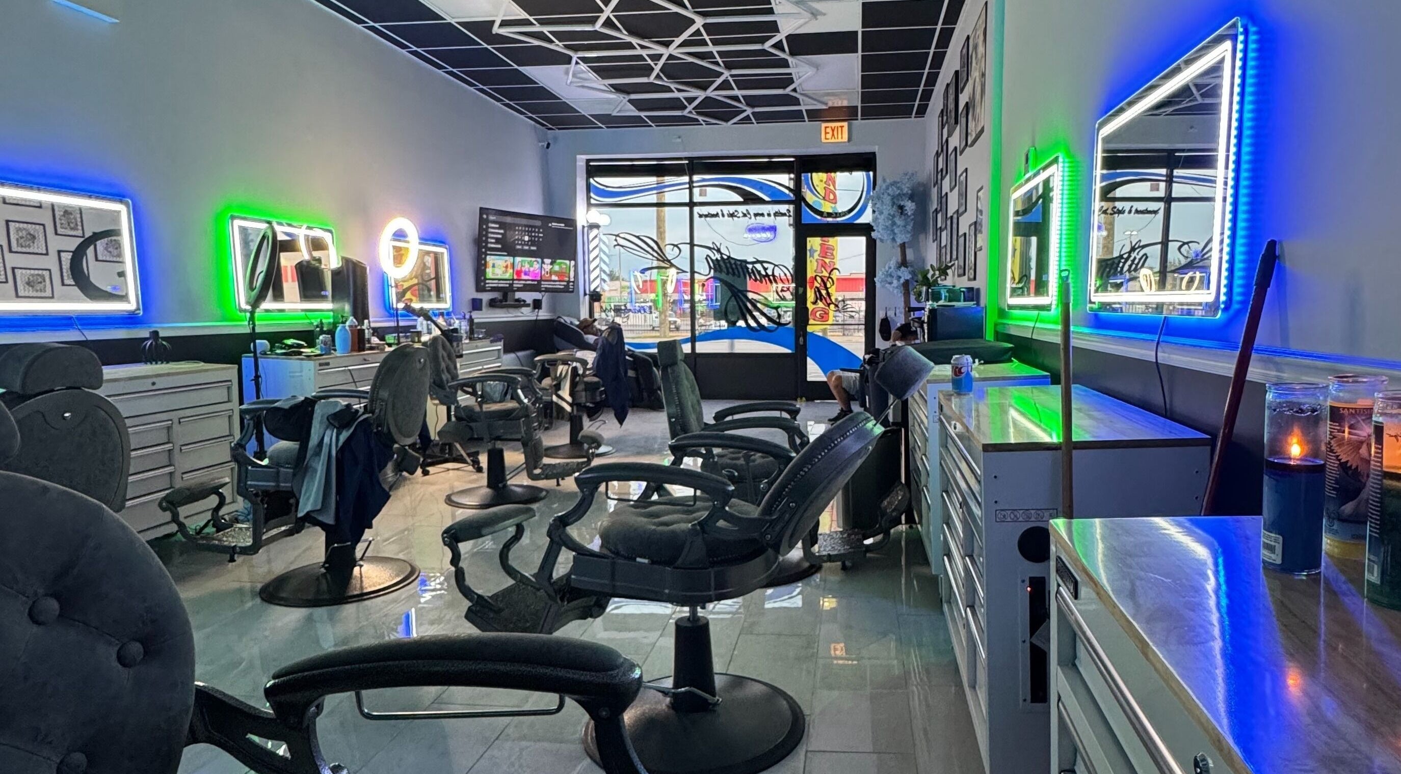 Modern interior of La Familia Barbershop in Chicago, Illinois, US with neon lights and styling chairs.