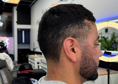 Side view of a fresh fade haircut at La Familia Barbershop, Chicago, Illinois, US.