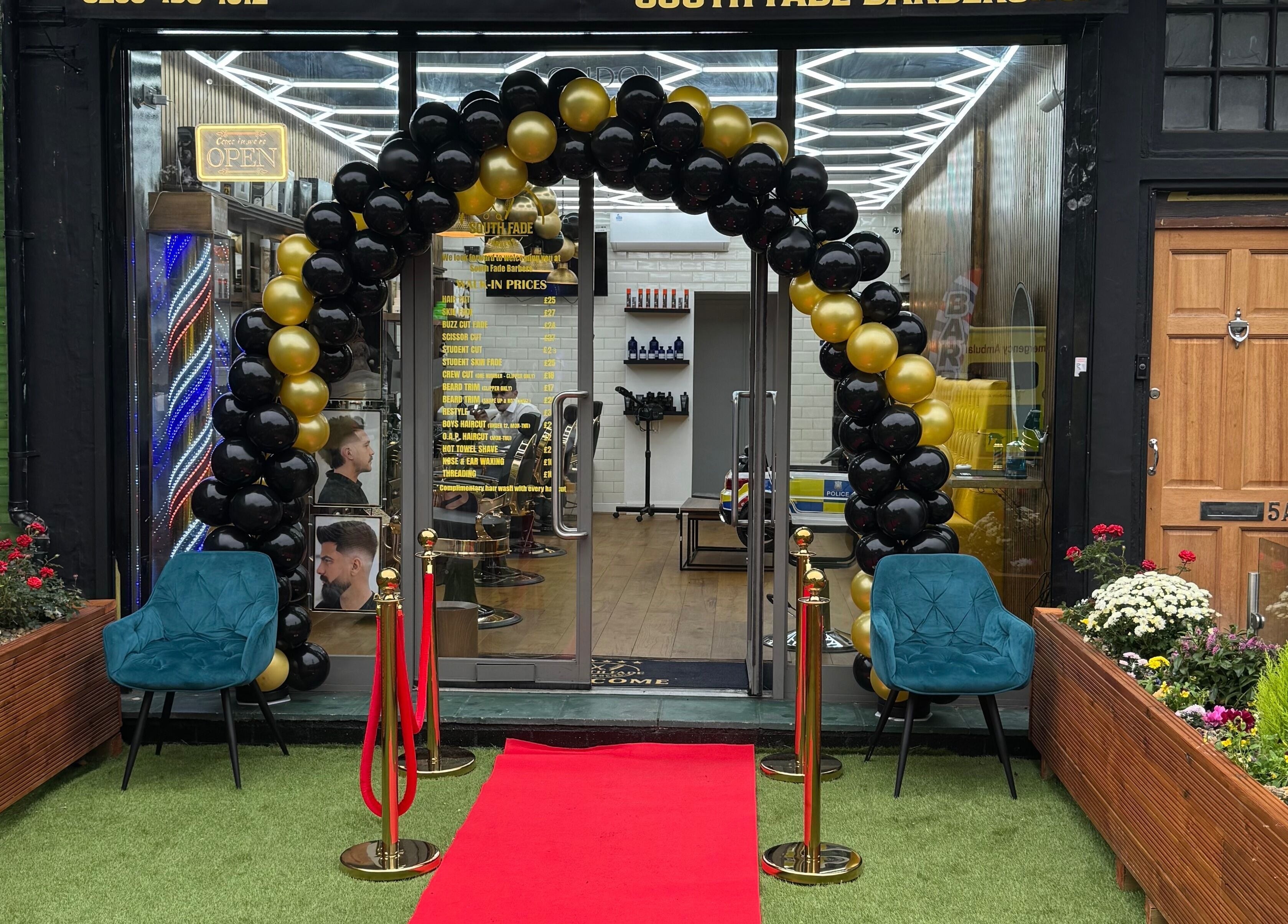 South Fade Barbers entry with balloon arch and red carpet in London, England, GB.