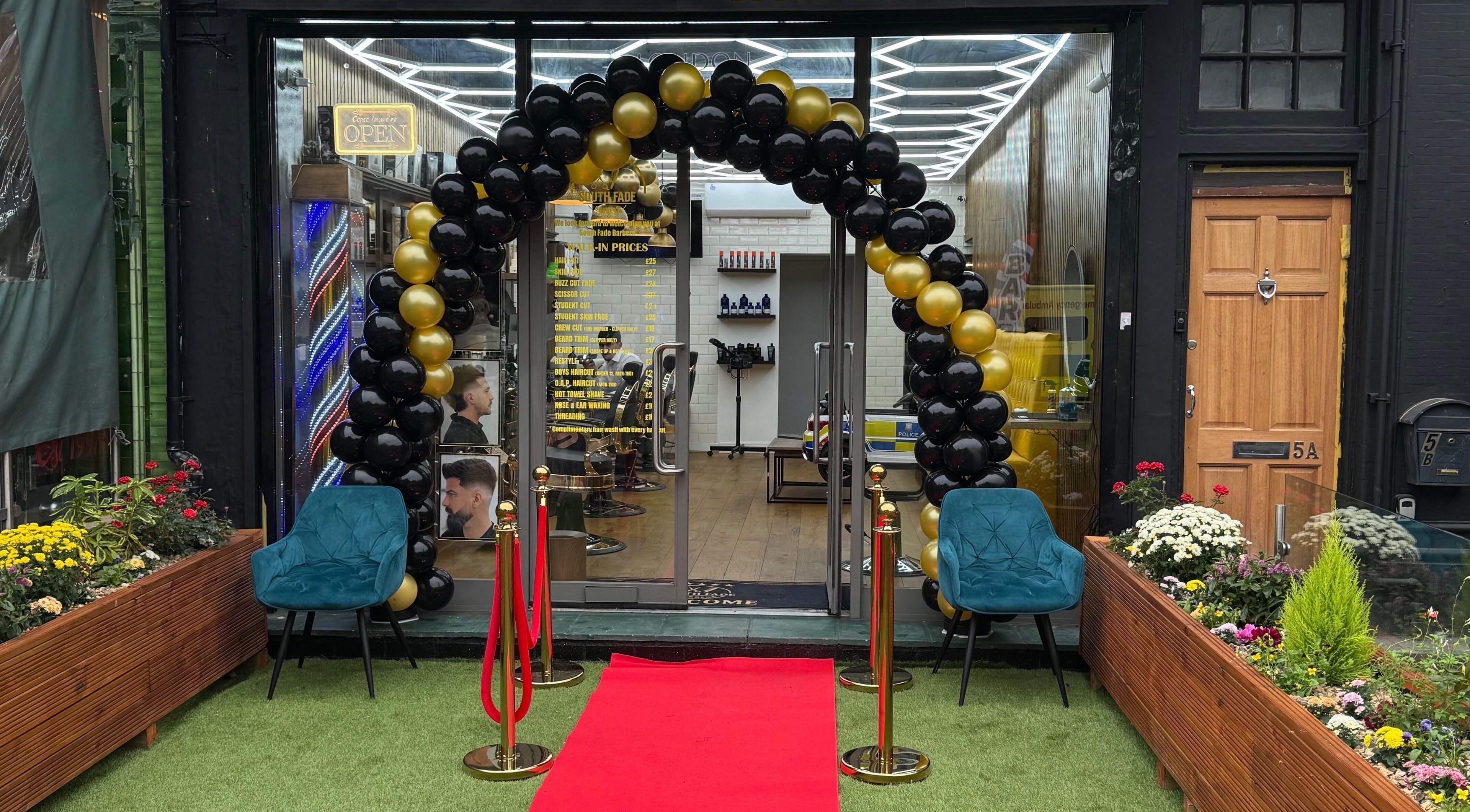 South Fade Barbers entry with balloon arch and red carpet in London, England, GB.