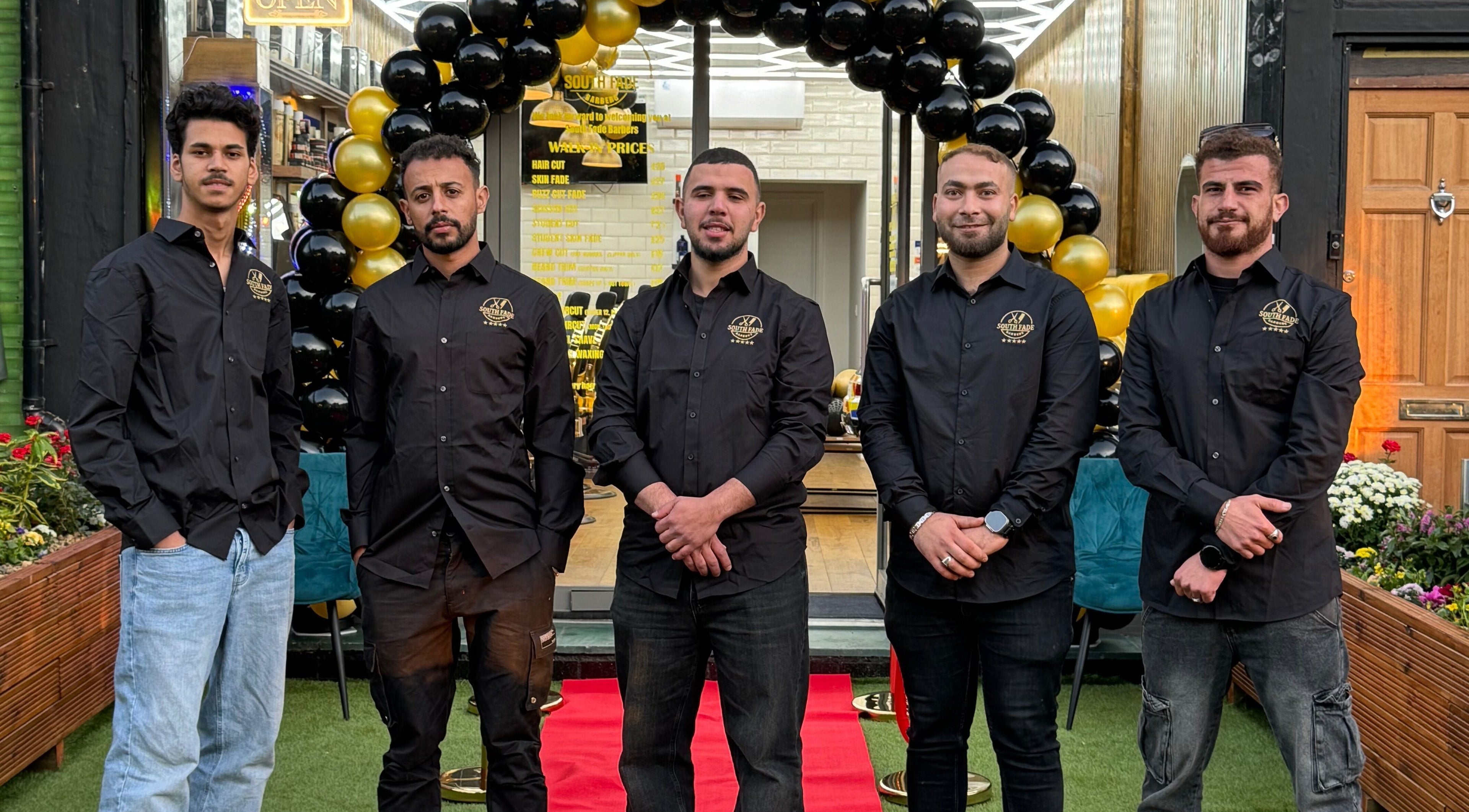 Team outside South Fade Barbers in London, England, GB, ready to welcome customers.