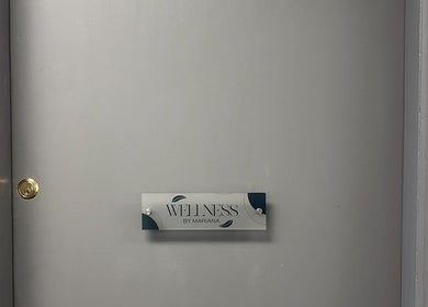 Entrance door of Wellness by Mariana in Southampton, England, GB with elegant sign.