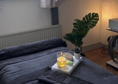 Calm massage room at Wellness by Mariana, Southampton, England, GB with candle and greenery decor.