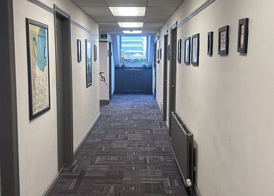 Bright corridor at Wellness by Mariana in Southampton, England, GB, adorned with framed art and plants.